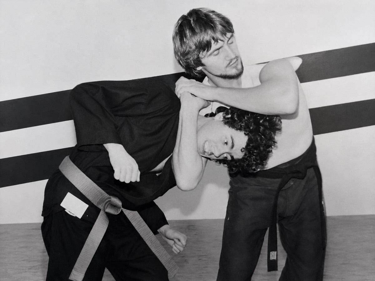 Scott Batey applying a standing jiu-jitsu clinch on a training partner in the dojo.